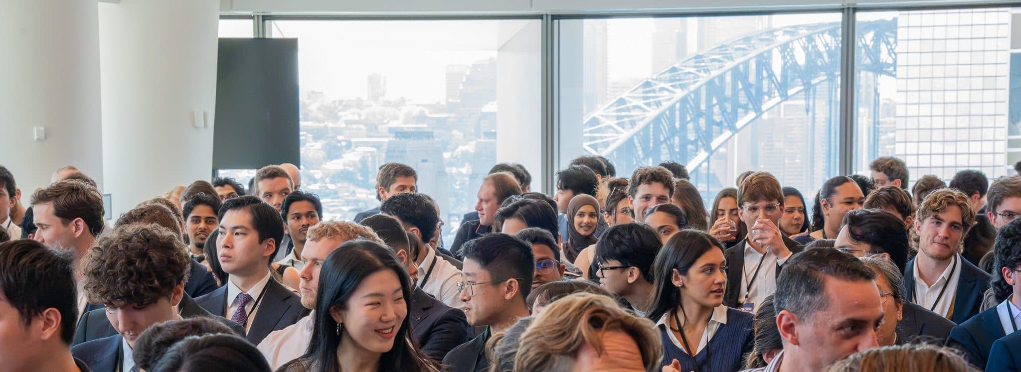 Candidates in the audience at Brimstone Sydney 2026, with the Sydney Harbour Bridge behind them